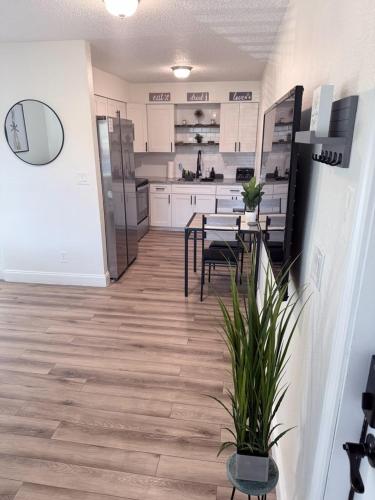 a kitchen with white cabinets and a table and chairs at Tampa Bays Hidden Gem in Tampa