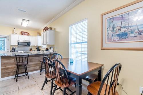 a dining room with a table and chairs in a kitchen at Orange Beach Villas - Serendipity in Orange Beach