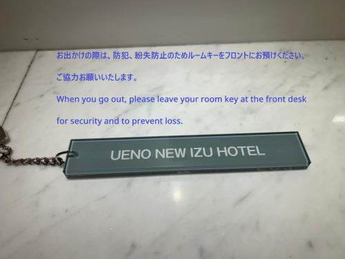 a sign that is attached to a chain at Tokyo Ueno New Izu Hotel in Tokyo