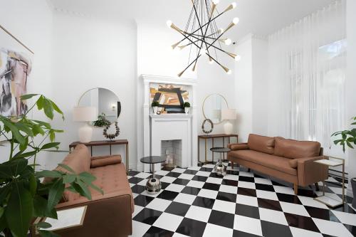 a living room with a couch and a fireplace at Kozy Stays Penfield - Modern Rooms Heart of downtown in Montréal