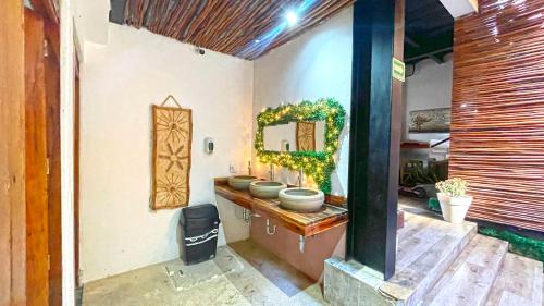 a bathroom with four toilets on a wall at Mr Pakal Tulum in Tulum