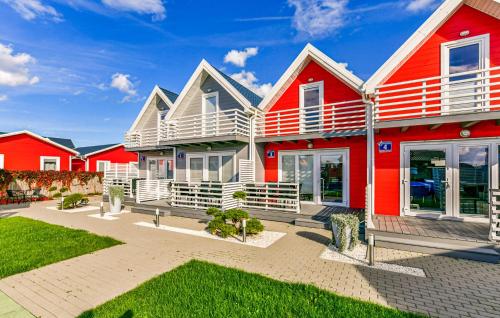 a row of houses with red and white at Stunning Home In Sarbinowo in Sarbinowo