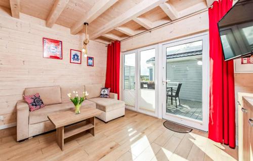 a living room with a couch and a table at Stunning Home In Sarbinowo in Sarbinowo