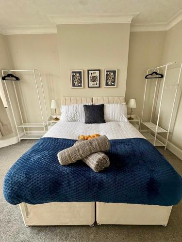 a bedroom with a large bed with two pillows on it at Stylish Southend 4 Bed Sleeps 7 FastWifi Secure Driveway Parking by The Opulent Property Project UK in Southend-on-Sea