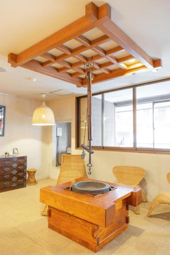 a living room with a table and some chairs at Address Nozawa in Nozawa Onsen