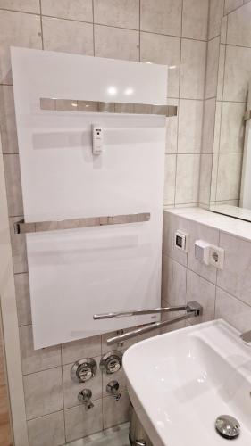 a white bathroom with a sink and a mirror at Schöner Blick in Am Schwarzen Busch