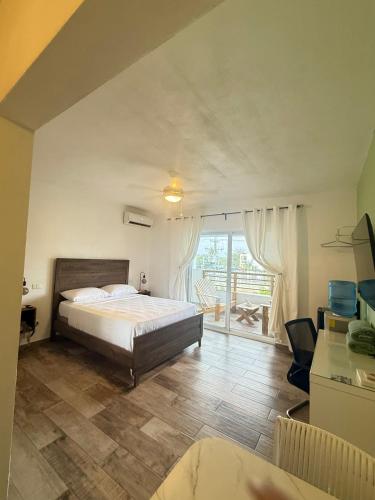 a bedroom with a bed and a large window at Vista Bayahibe Paradise in Bayahibe