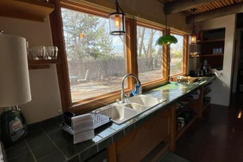 a kitchen counter with a sink and a window at Santuario Grande in Los Ranchos de Albuquerque