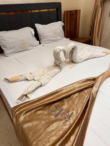 a stuffed animal on a bed in a hotel room at CASA Hamburg NADOR AL JADID in Nador