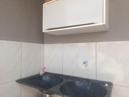 a bathroom with a sink and a white cabinet at Hostel de clecia in Extremóz