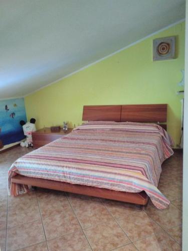 a bedroom with a large bed with a striped bedspread at Soggiorno in Relax in Correggioverde