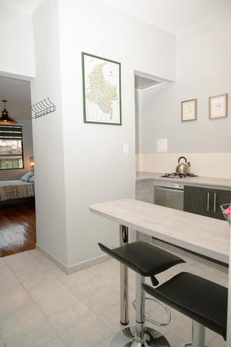 a kitchen with white walls and a table with a chair at El Caracol in Popayan