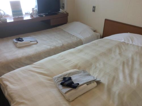 Postel nebo postele na pokoji v ubytování Hotel Togane Hills