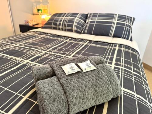 a bed with two pillows and a chair on it at Bulgon Lodge in Collinsville