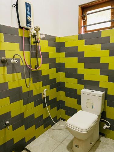 a bathroom with a shower with a toilet at Golden Palace Yala in Tissamaharama