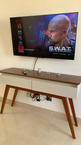 a flat screen tv sitting on a wall at Apartamento SN Orlando Dantas in Aracaju