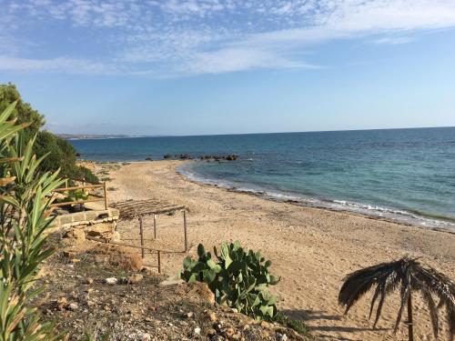 a sandy beach with the ocean in the background at Villa Sciacca Lumia LUNA in Sciacca