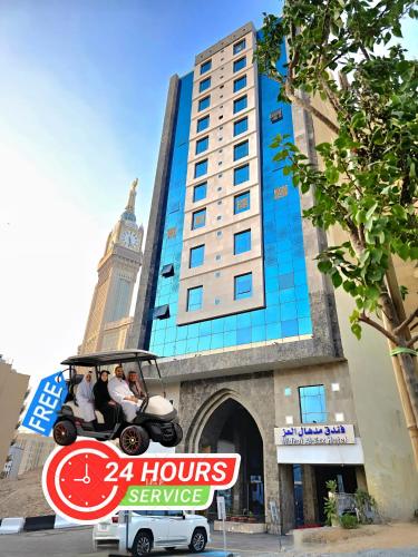 a golf cart parked in front of a building at Midhal Al Ezz Ajyad Hotelفندق مدهال العز in Mecca