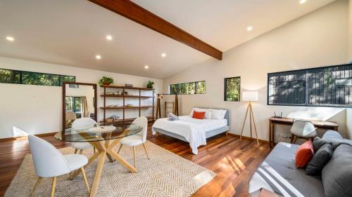 a bedroom with a bed and a table and chairs at Beautiful high-set studio close to beach in Ocean Shores