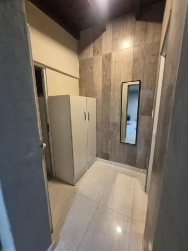 a room with a white refrigerator and a mirror at Pardo Mza in Godoy Cruz