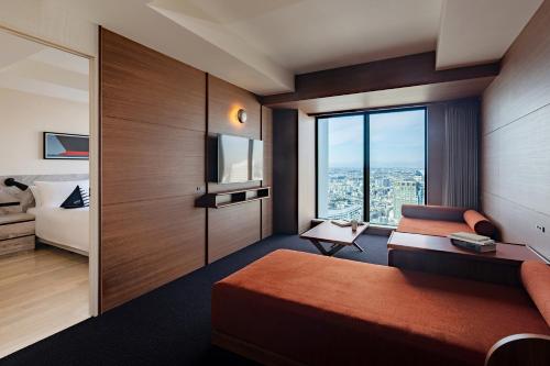 a hotel room with a bed and a television at OMO5 Yokohama Bashamichi by Hoshino Resorts in Yokohama