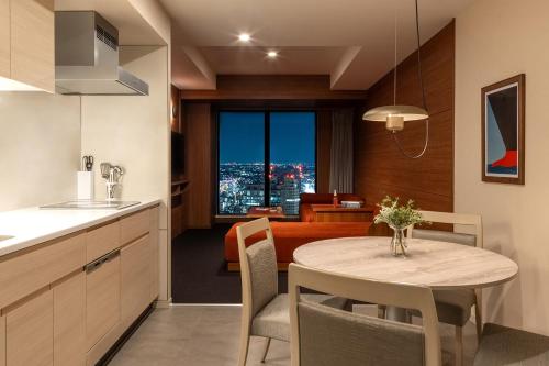 a kitchen and dining room with a table with a view at OMO5 Yokohama Bashamichi by Hoshino Resorts in Yokohama