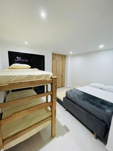 a bedroom with a large bed and a fireplace at Villa Sierra Mar in Playa Bello Horizonte