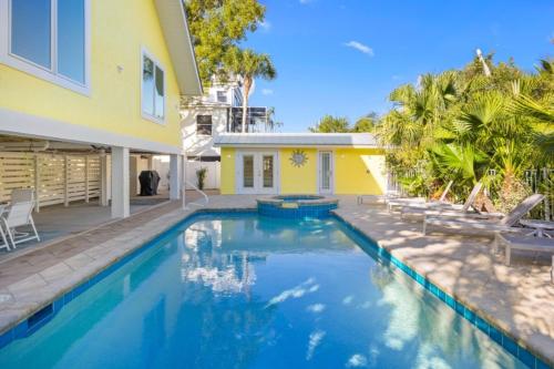 a swimming pool in front of a house at Amarelo Sol in Captiva