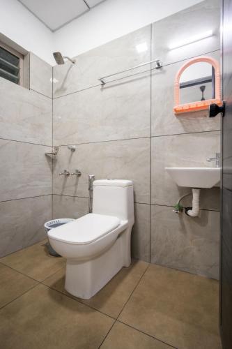 a bathroom with a toilet and a sink at FORA Inn in Cochin
