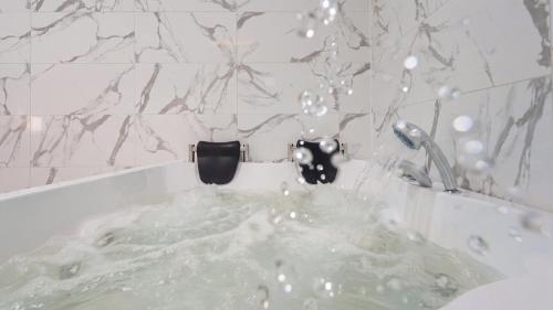 a bath tub with water coming out of it at Gapyeong Orion PoolVilla pension in Gapyeong
