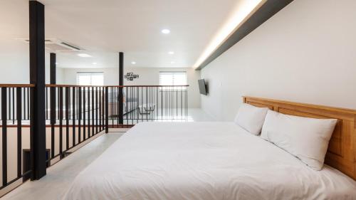 a bedroom with a bed and a balcony at Gapyeong Orion PoolVilla pension in Gapyeong