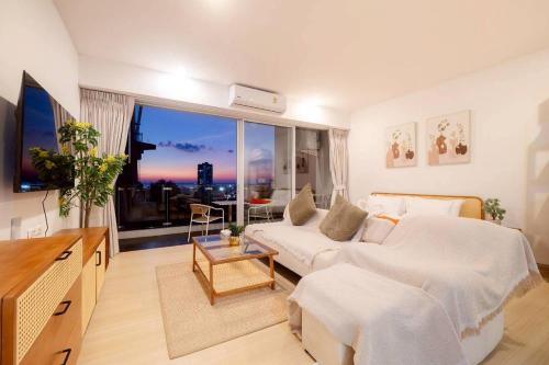 a hotel room with a bed and a large window at Seaview Residence Karon beach in Karon Beach