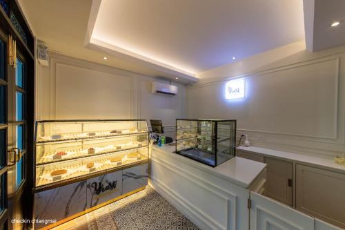 a display case in a room with many pastries at Buri Sriping Riverside Resort & Spa in Chiang Mai