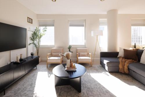 a living room with a couch and a tv at RARE Luxurious Apartment 1 Block From Time Square in New York