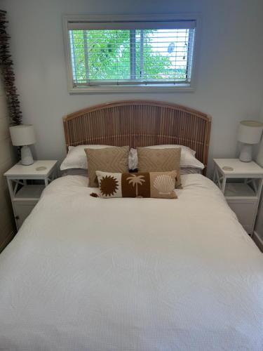 a bedroom with a large bed with two night stands at 5 min stroll to the heart Of Huskisson in Huskisson