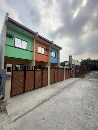 a house with a fence in front of it at Apt101 Guest House in Bacoor
