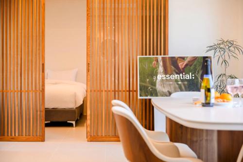a room with a bed and a table and chairs at Hold in Hamdeok with Pool in Jeju