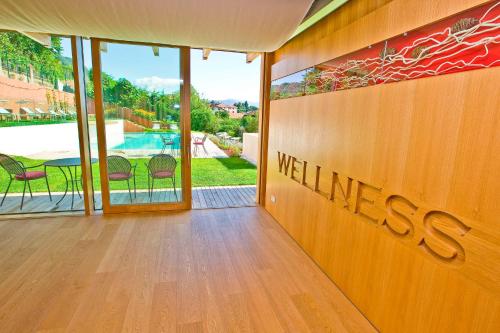 a wall with the word wellness written on it at Hotel Goldener Stern in Caldaro