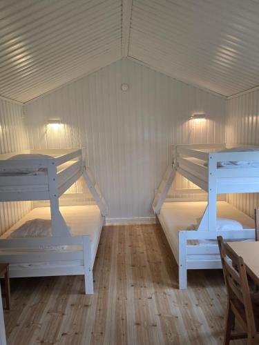 a room with two bunk beds and a table at Edsken Camping in Hofors