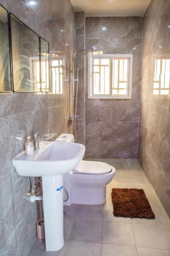 a bathroom with a sink and a toilet at The View Apartments Salagi in Brusubi