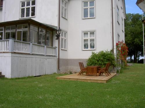 a house with two chairs and a table in the yard at Södra Lund B&B in Vreta Kloster