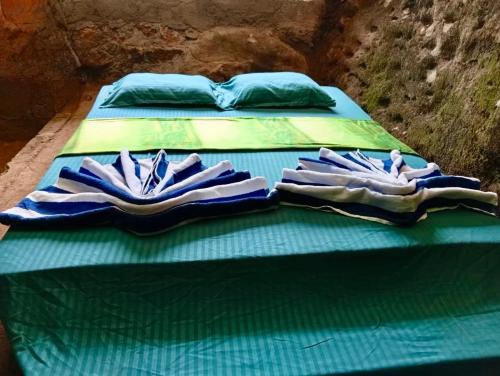 two twin beds sitting next to each other at Sinharaja-Forest Cave Camp in Ullinduwawa