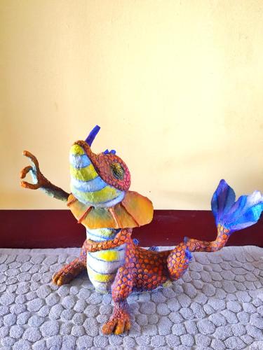 a stuffed animal is sitting on a bed at Camellia B&B in Taitung City