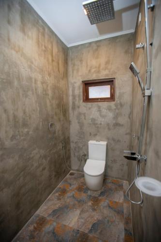 a bathroom with a toilet and a sink at The Lux Villa in Habaraduwa Central