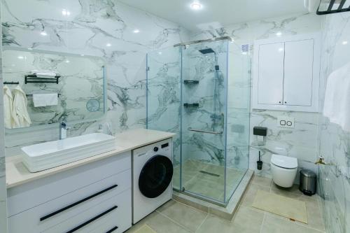 a bathroom with a shower and a washing machine at Гостиница Караганда in Karagandy