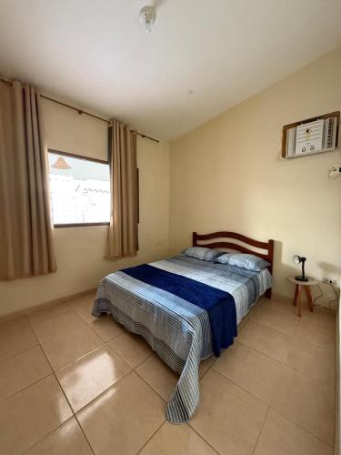 a bedroom with a bed in the corner of a room at Casa Refúgio Tamandaré in Tamandaré