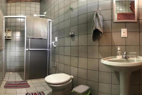 a bathroom with a toilet and a sink at Casa Refúgio Tamandaré in Tamandaré