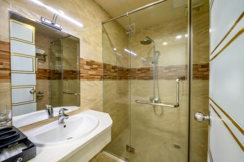 a bathroom with a sink and a shower at Happy Light Central Nha Trang in Nha Trang