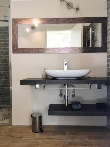 a bathroom with a sink and a mirror at Maglo Centro in Bologna