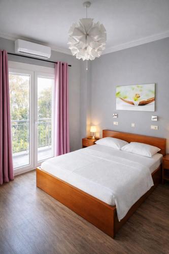 a bedroom with a large bed and a large window at Hotel Europa - Family and Senior Friendly in Kavála